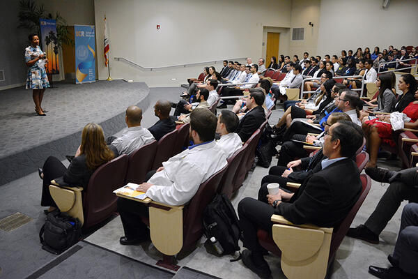 Deas speaking to audience