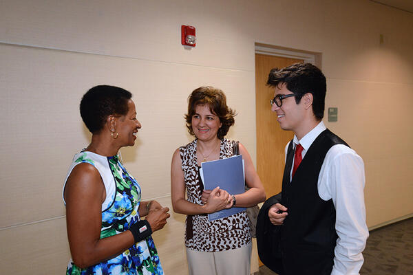 Deas speaking with guests